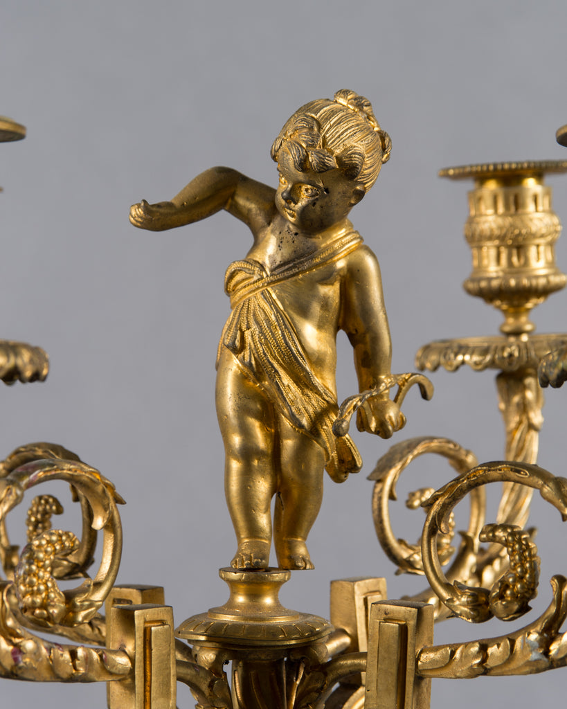 Pair of French ormolu candelabras with cherub on top